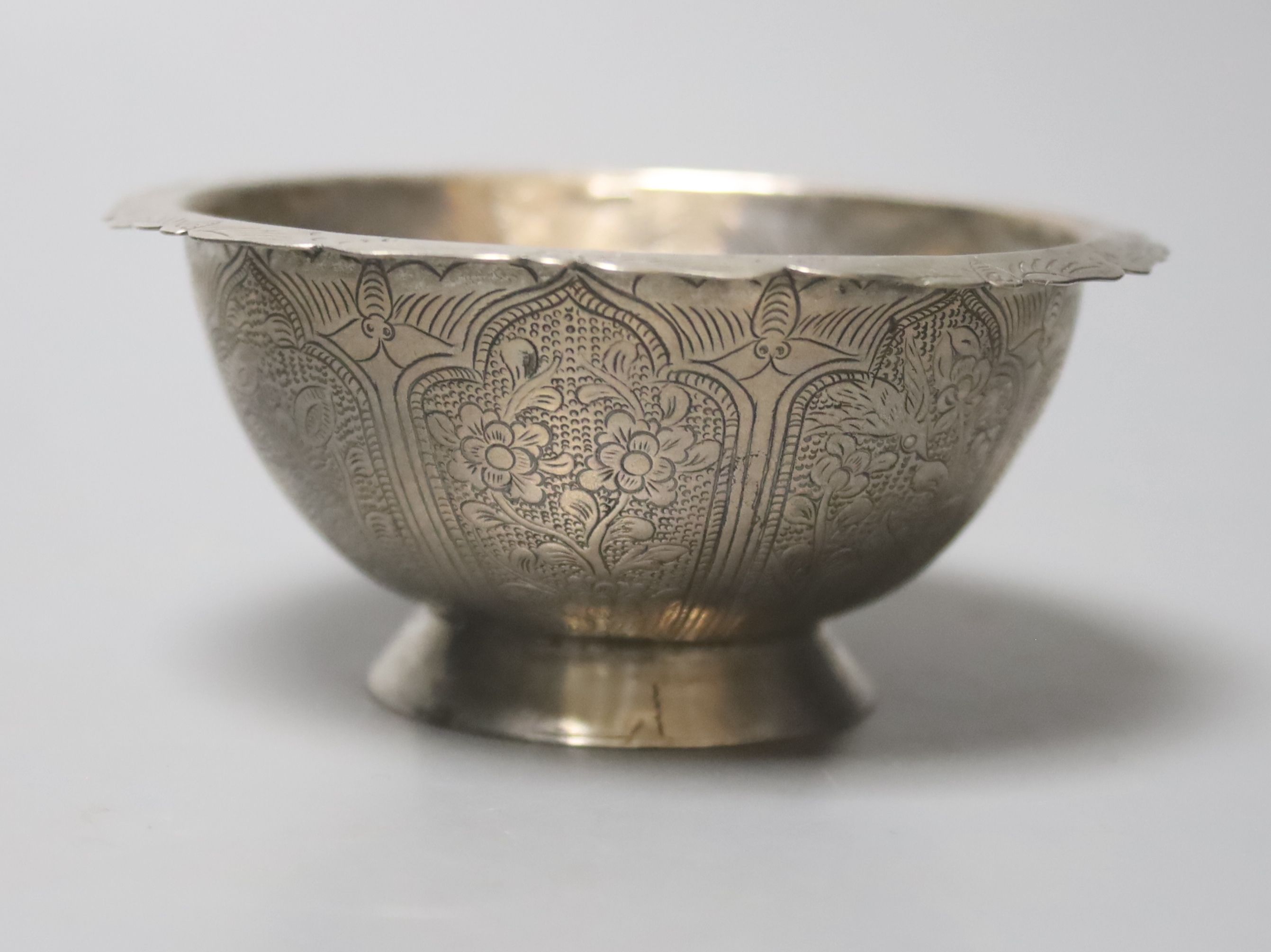 A Chinese small metal bowl, decorated with a floral design, Tang dynasty style, 9cm diameter 4cm high